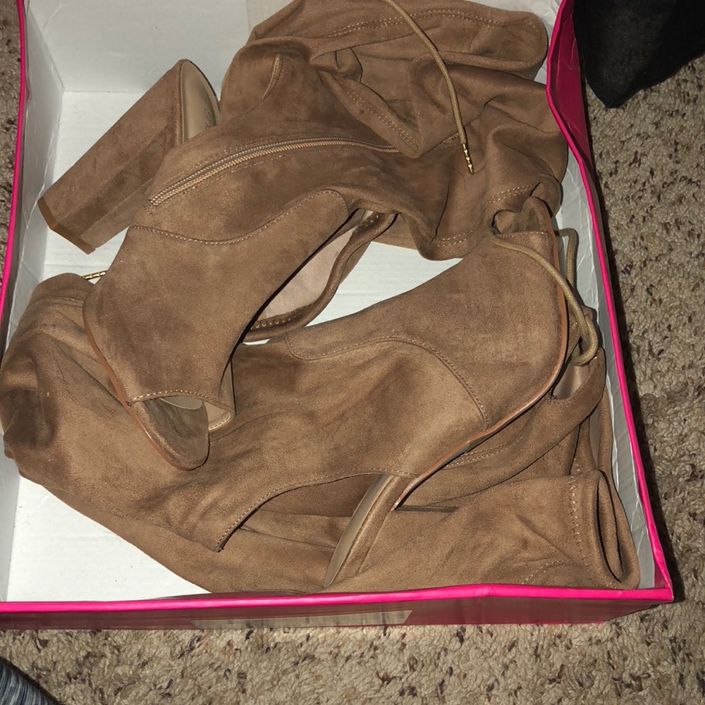 Thigh high heeled boots.